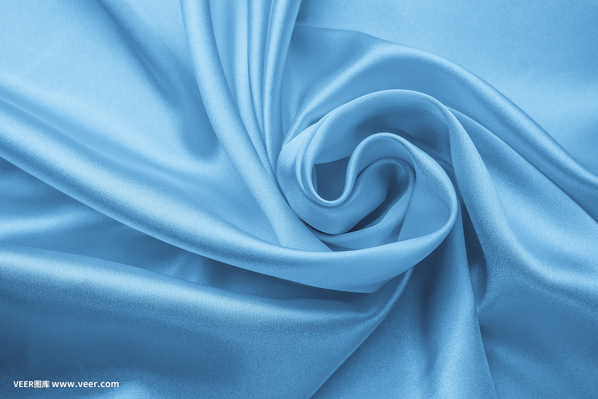 柔和的波浪色材料,蓝色有光泽的纺织品。缎子褶皱,波浪图案。丝质背景曲线,奢侈时尚。折叠布,墙纸。